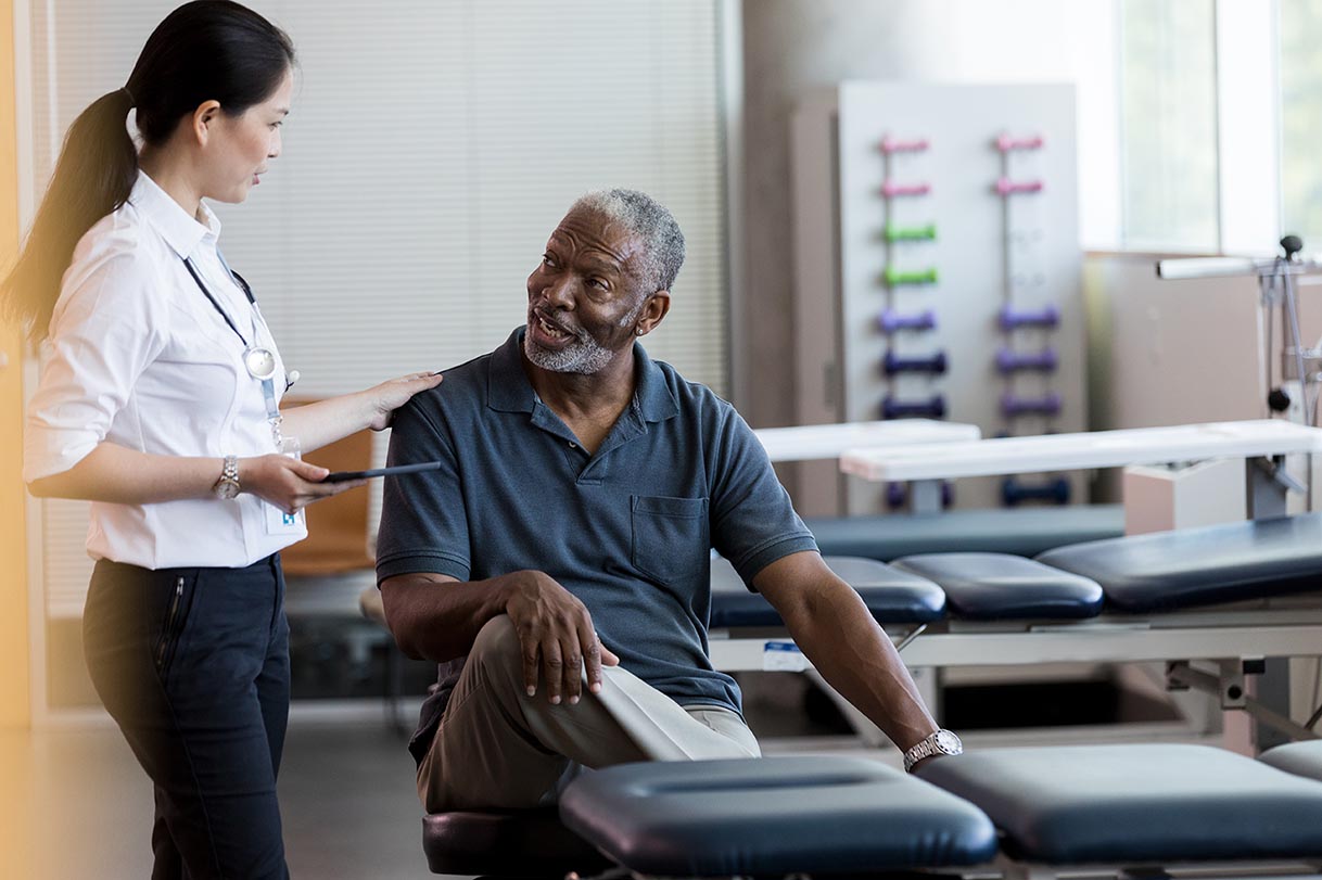 Confident female doctor visits with senior patient